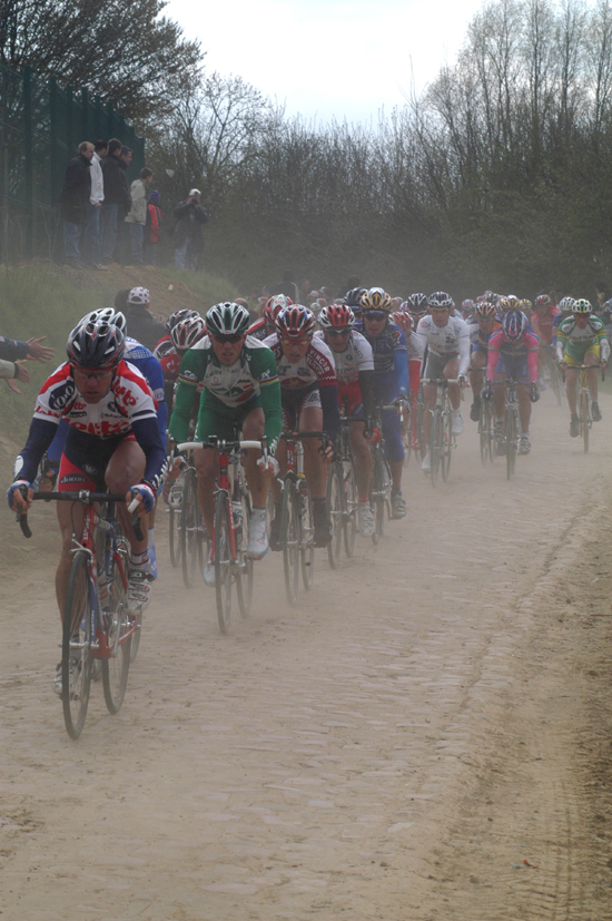 Riders raise dust over the cobbles